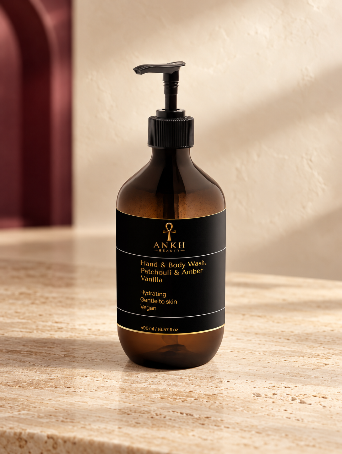 Hand & Body Wash, Patchouli & Amber Vanilla, original Ankh Beauty packaging on warm ivory stone