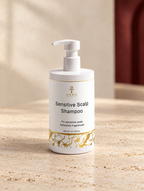 Sensitive Scalp Shampoo, original Ankh Beauty packaging on warm ivory stone